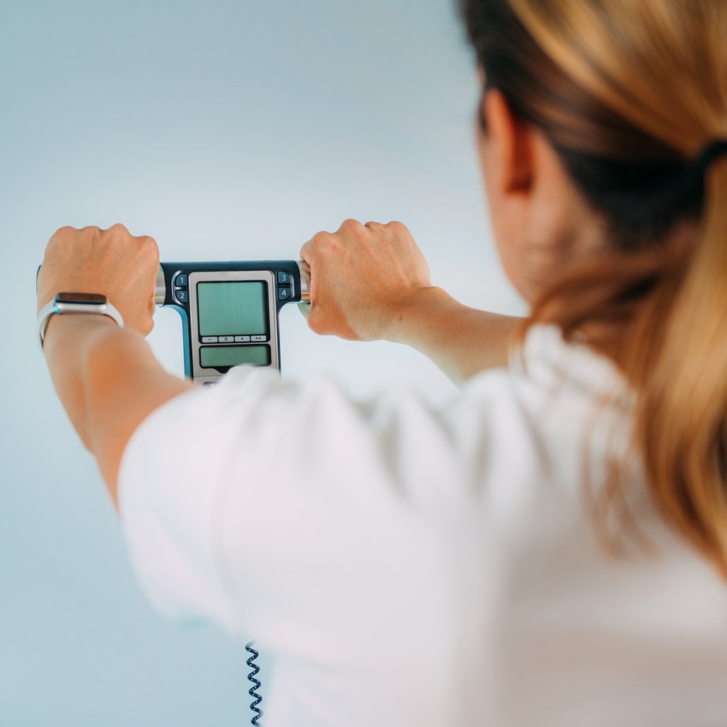 Woman Holding a Handheld Body Impedance Monitor 